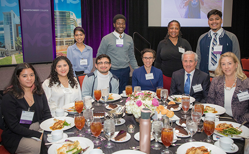 Donors Cliff and Debbie White (seated, front-right) with ACES students they support via the Cliff and Deborah White ACES Pathway Champions Scholarship along with Universities at Shady Grove Executive Director Anne Khademian (seated, third from right) and Director of ACES Karen Callender-Price (standing, second from right).